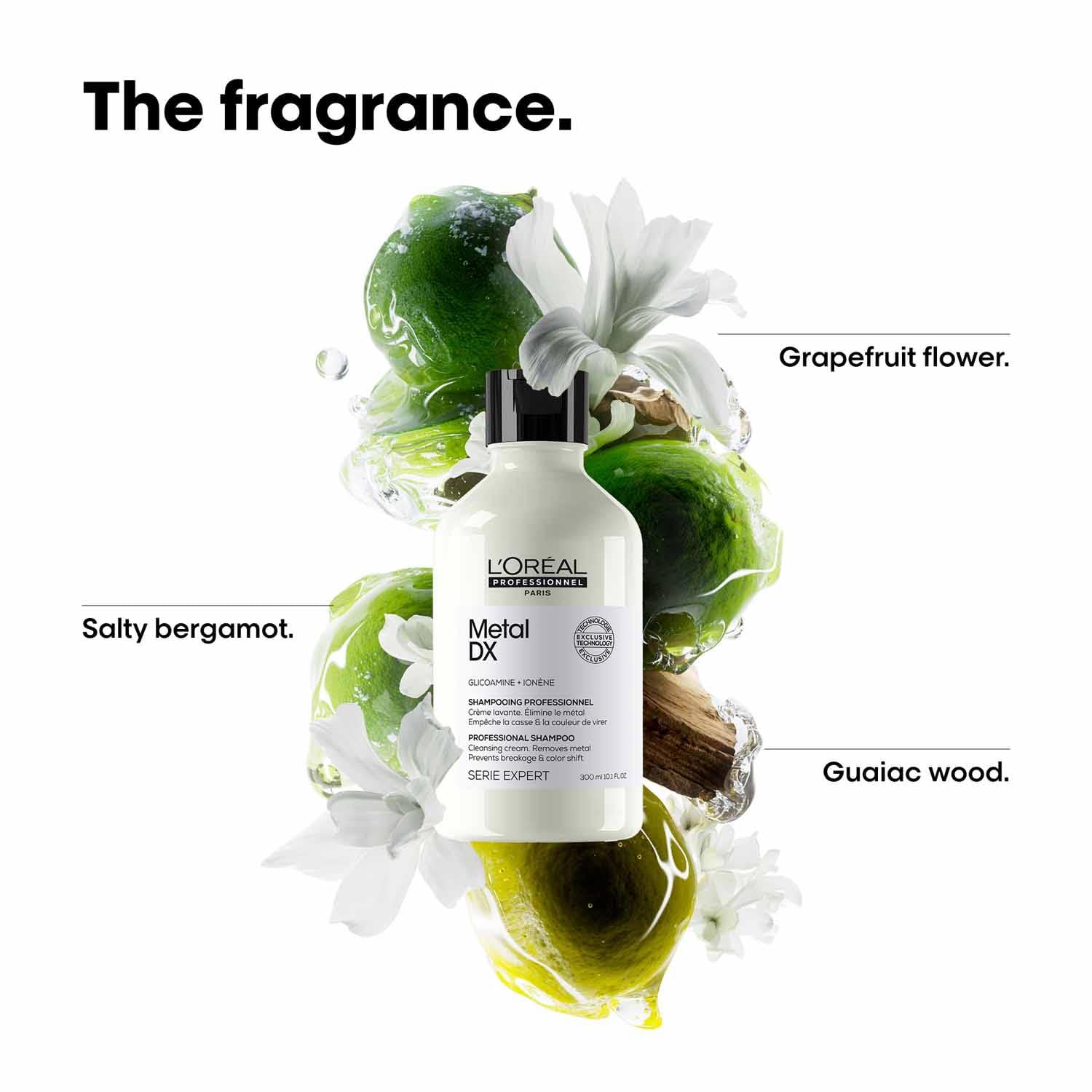 L'Oreal Metal DX shampoo bottle with green leaves and white flowers on a white background