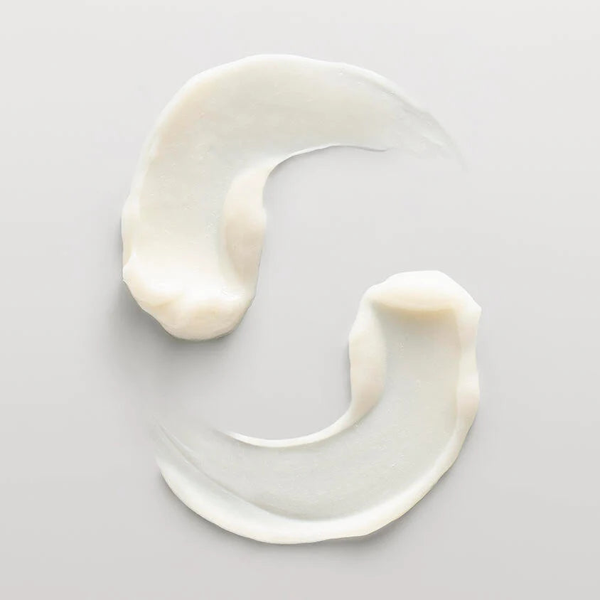 White cream or yogurt swirled on a light gray background