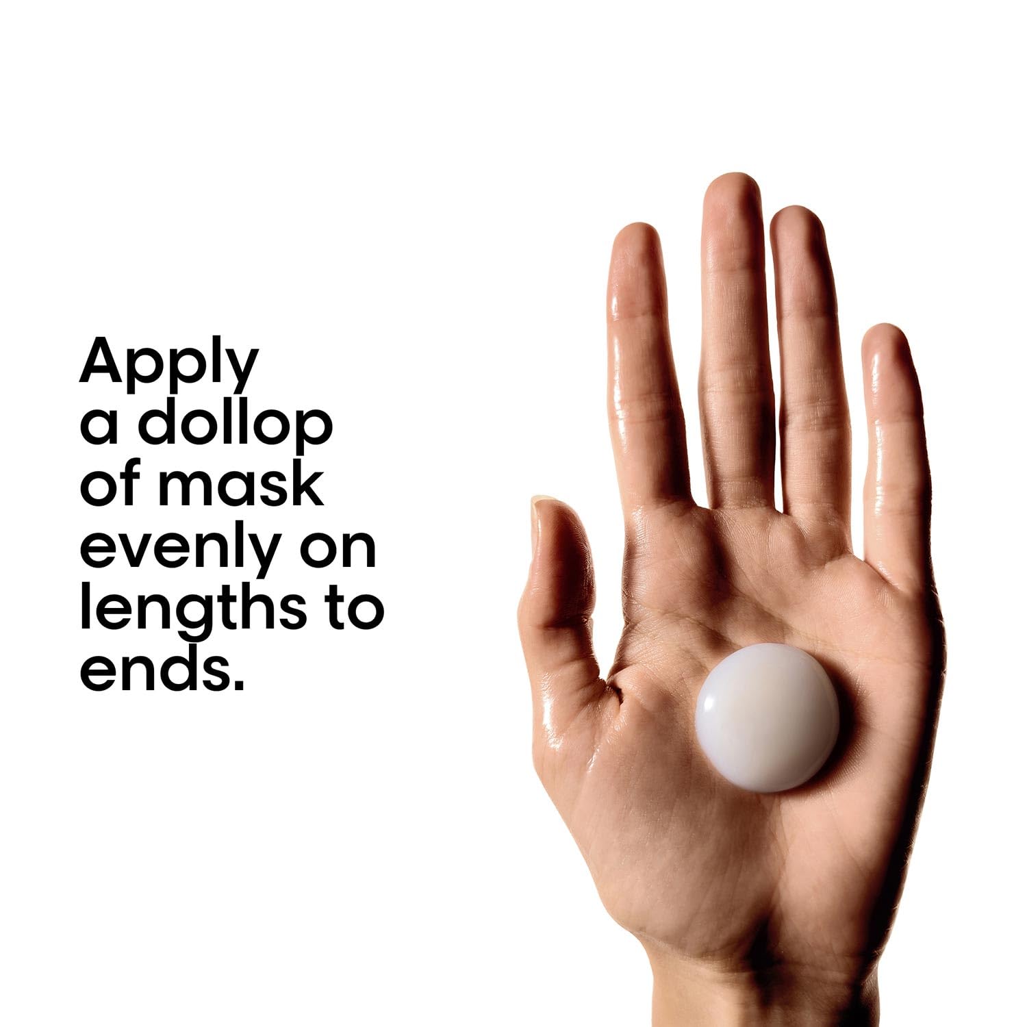 Hand holding a dollop of mask with text on applying it evenly.